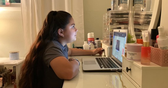 Anjelah Salazar, a fifth grade girl, sits at her desk in front of her computer.